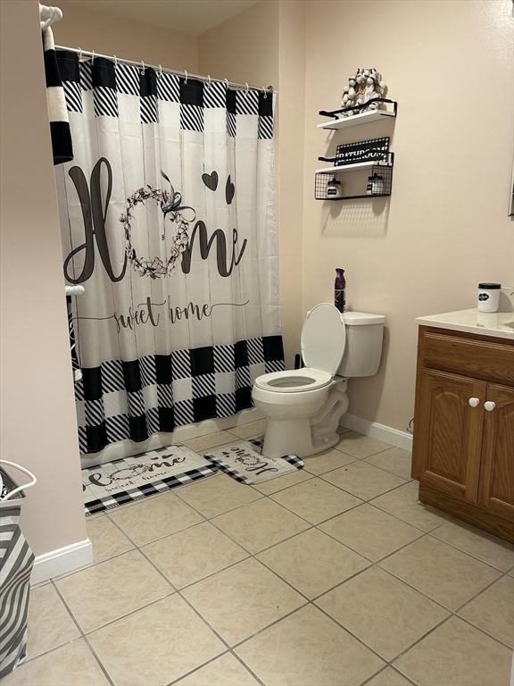 882 Brockton Ave Unit 10, Abington, MA 02351 - full bathroom with vanity, toilet, tile patterned floors, baseboards, and a shower with shower curtain