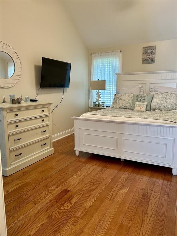 882 Brockton Ave Unit 10, Abington, MA 02351 - bedroom with vaulted ceiling, dark wood finished floors, and baseboards