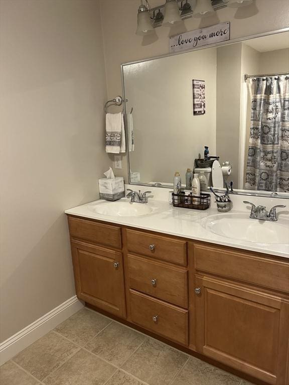 882 Brockton Ave Unit 10, Abington, MA 02351 - full bath with double vanity, baseboards, and tile patterned floors