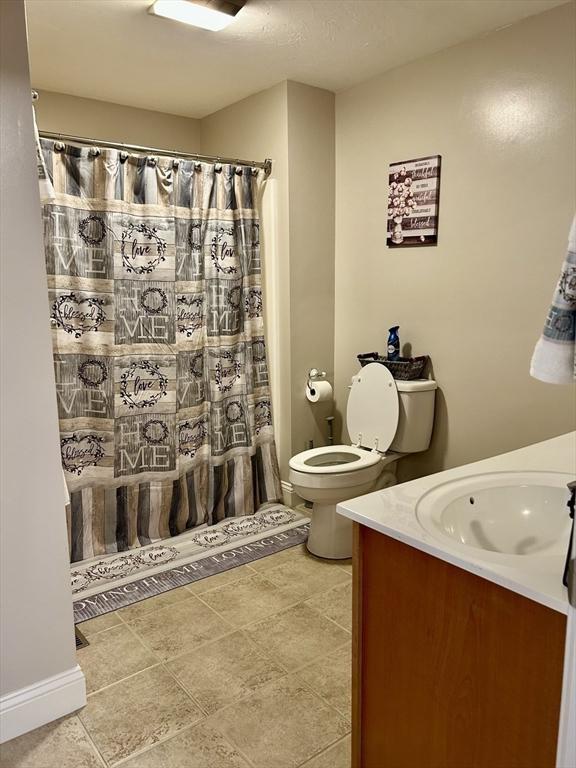 882 Brockton Ave Unit 10, Abington, MA 02351 - bathroom with vanity, toilet, and curtained shower