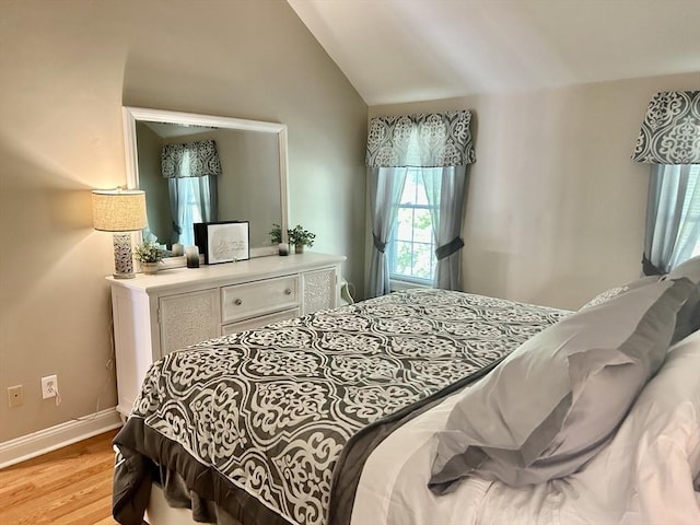 882 Brockton Ave Unit 10, Abington, MA 02351 - bedroom with light wood finished floors, vaulted ceiling, and baseboards