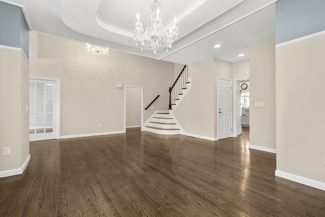 unfurnished living room with recessed lighting, dark wood-type flooring, stairs, and a notable chandelier