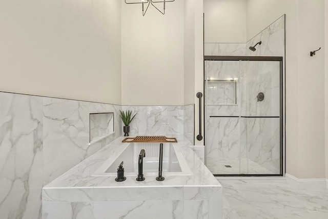 full bathroom featuring a marble finish shower, a garden tub, and marble finish floor
