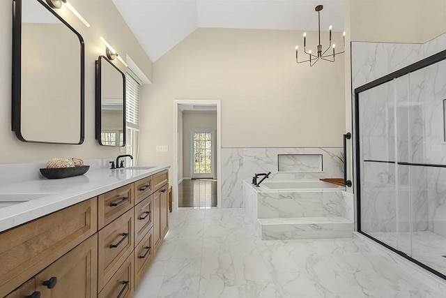 bathroom with a sink, marble finish floor, a marble finish shower, and a notable chandelier