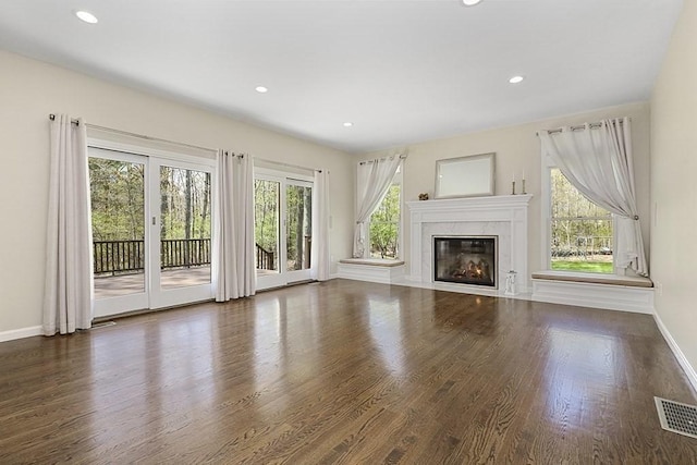unfurnished living room featuring recessed lighting, baseboards, visible vents, and wood finished floors