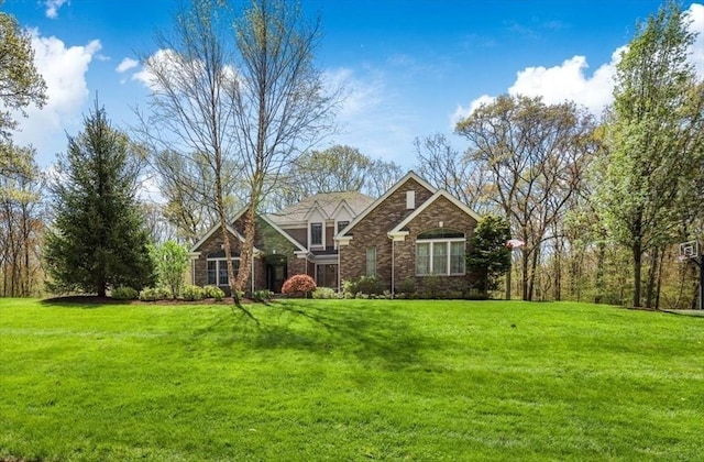 view of front of property featuring a front lawn and stone siding