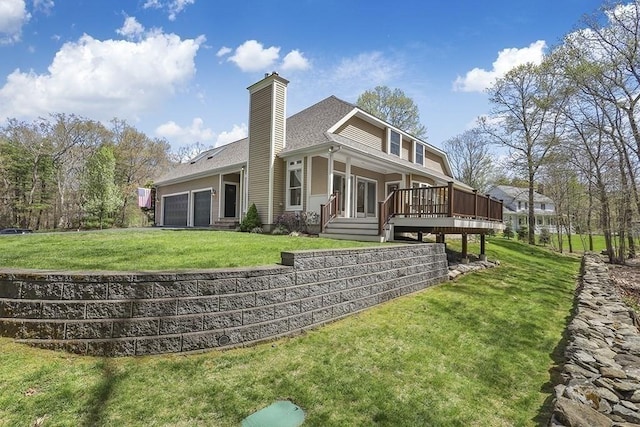 rear view of property featuring a lawn, a deck, an attached garage, and a chimney