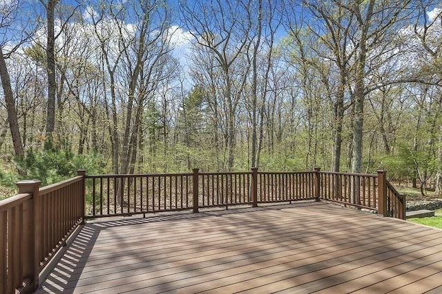 wooden deck featuring a view of trees
