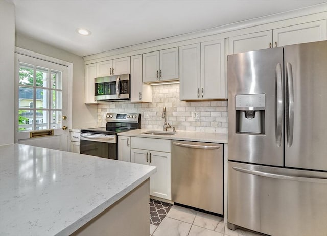 50 Lake St Unit B, Winchester, MA 01890 - kitchen featuring appliances with stainless steel finishes, tasteful backsplash, white cabinets, light stone countertops, and recessed lighting