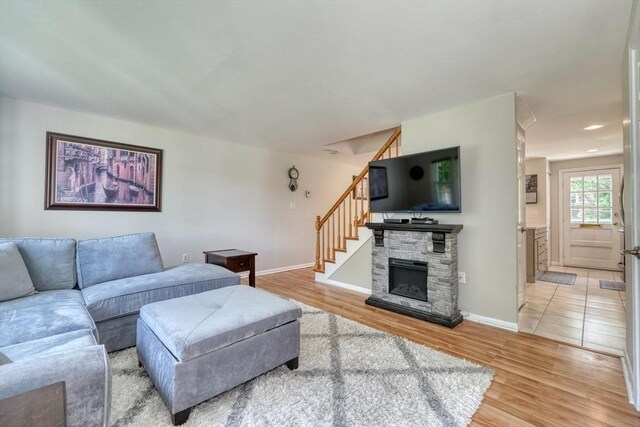 50 Lake St Unit B, Winchester, MA 01890 - living area with light wood-type flooring, stairs, and a stone fireplace