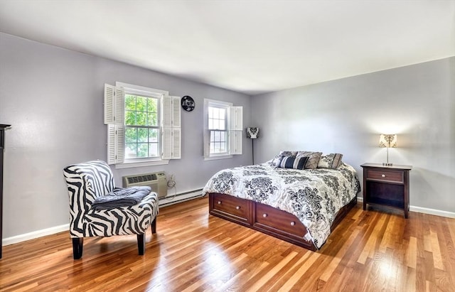 50 Lake St Unit B, Winchester, MA 01890 - bedroom featuring a baseboard heating unit, wood finished floors, and a wall unit AC