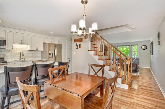 50 Lake St Unit B, Winchester, MA 01890 - dining area with light wood-type flooring, a chandelier, stairway, and recessed lighting