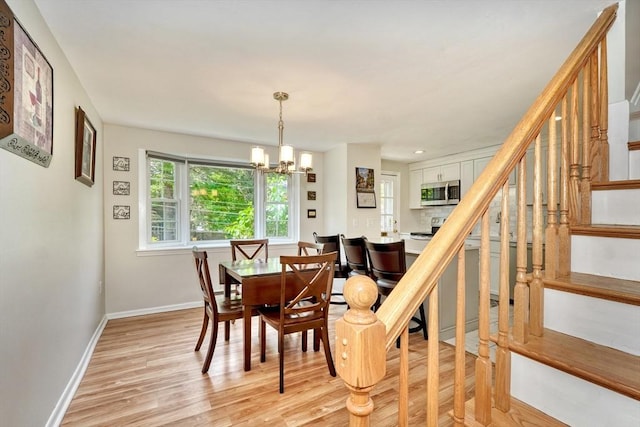 50 Lake St Unit B, Winchester, MA 01890 - dining space featuring stairway, a chandelier, and light wood-style flooring
