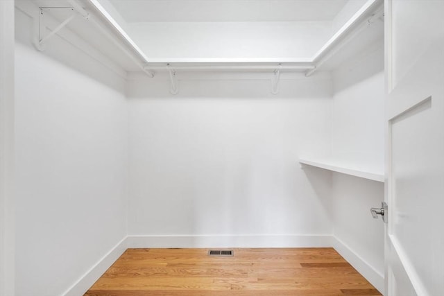 walk in closet featuring hardwood / wood-style flooring