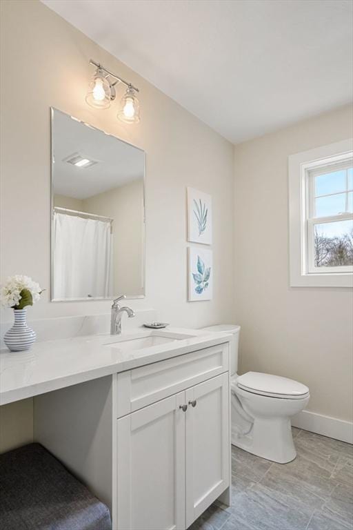 bathroom with toilet and vanity