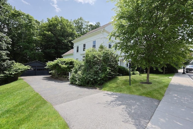 193 Main St, Medway, MA 02053 - view of side of home with a lawn, an outbuilding, and a garage