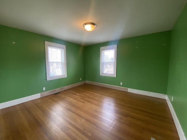 unfurnished room featuring hardwood / wood-style floors