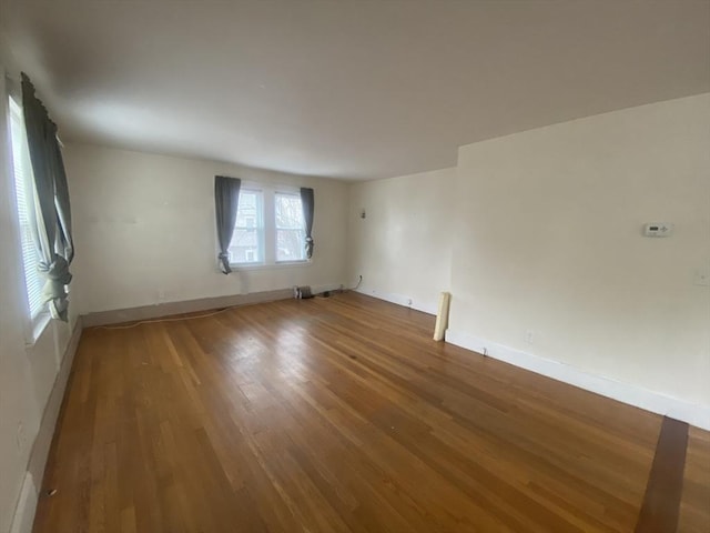 empty room with hardwood / wood-style floors