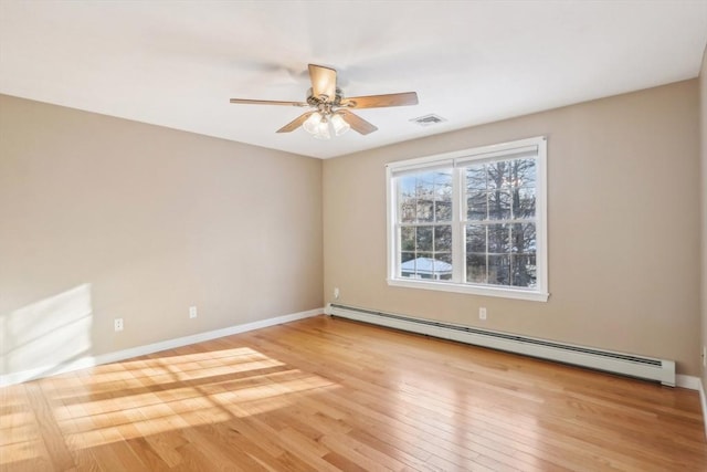 unfurnished room featuring a baseboard heating unit, ceiling fan, and light hardwood / wood-style floors