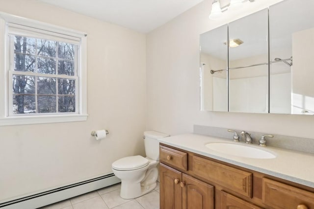 bathroom with toilet, vanity, tile patterned flooring, and a baseboard radiator