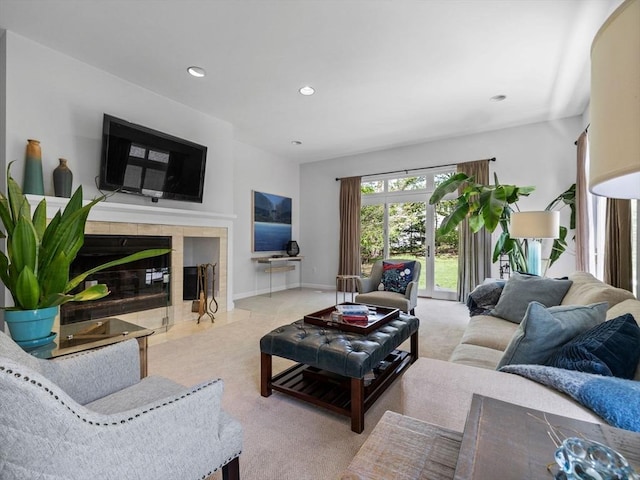 carpeted living room featuring recessed lighting, baseboards, and a tile fireplace