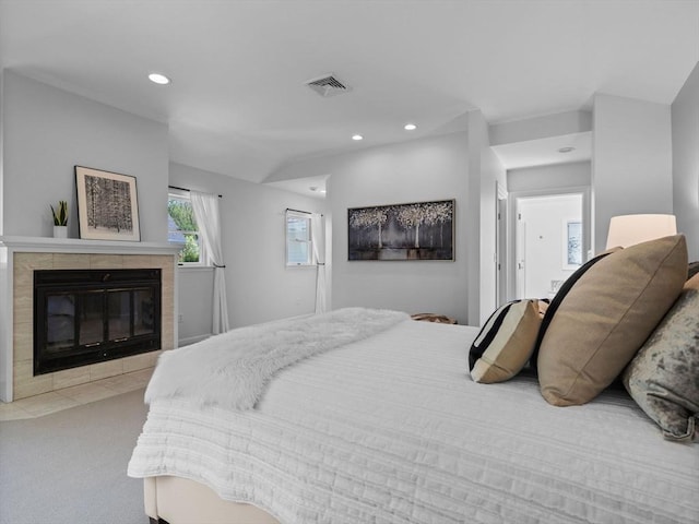 bedroom with visible vents, recessed lighting, carpet floors, and a fireplace