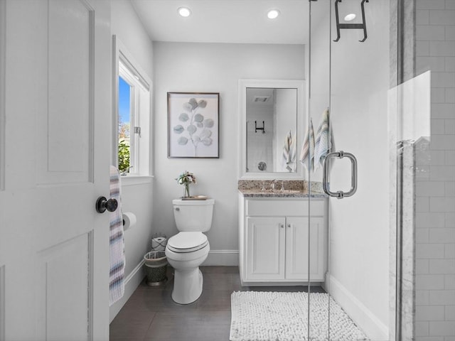 full bathroom featuring toilet, baseboards, wood finished floors, and vanity
