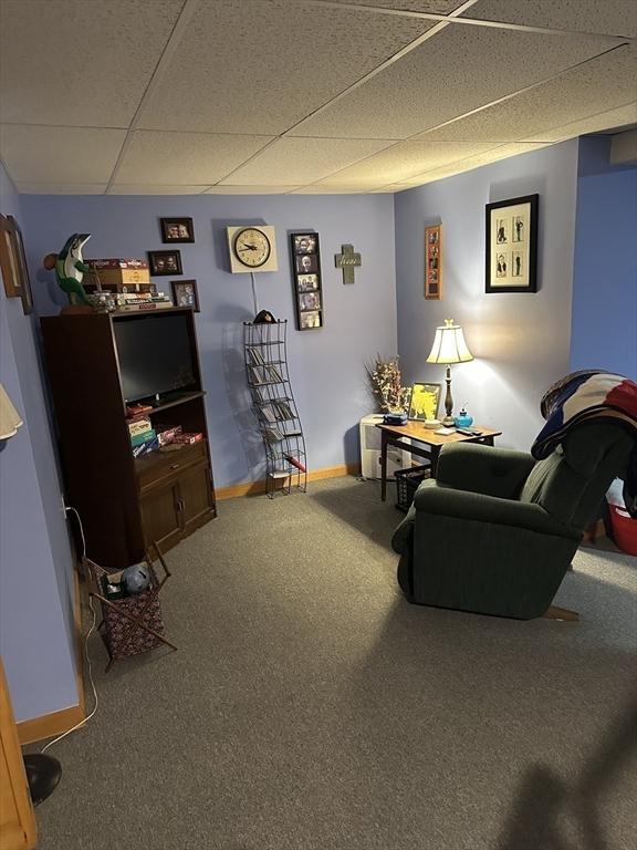 37 Teaberry Ln, Gardner, MA 01440 - living room with a paneled ceiling, carpet floors, and baseboards