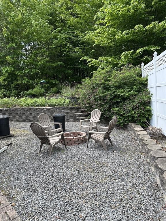 37 Teaberry Ln, Gardner, MA 01440 - view of patio / terrace with an outdoor fire pit and a forest view