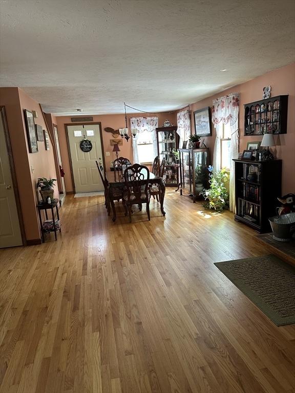 37 Teaberry Ln, Gardner, MA 01440 - dining area with light wood-style flooring and a textured ceiling