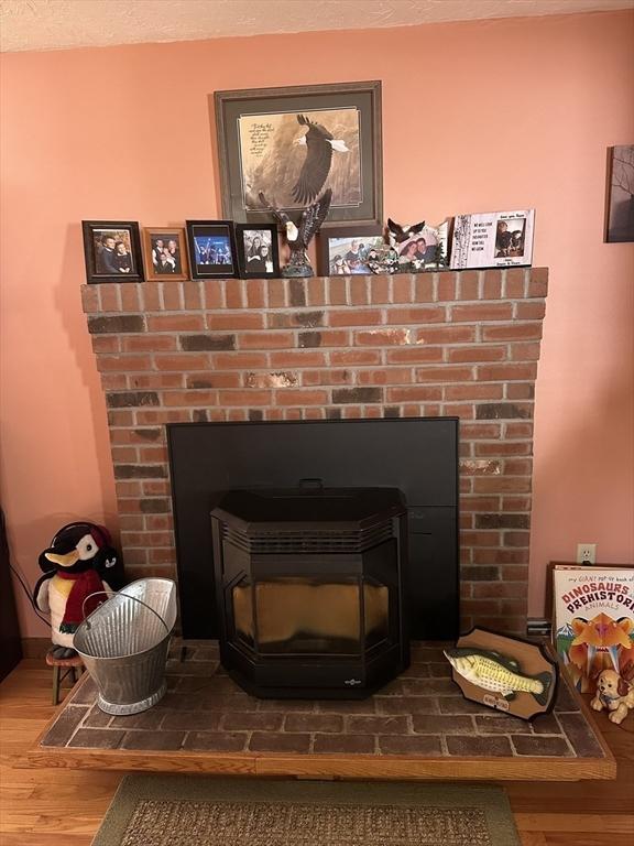 37 Teaberry Ln, Gardner, MA 01440 - detailed view of wood finished floors and a wood stove