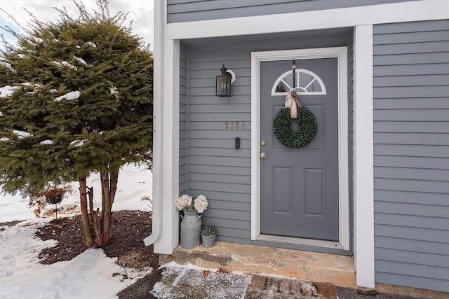 view of snow covered property entrance