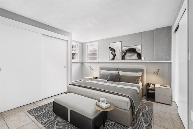 tiled bedroom with a closet