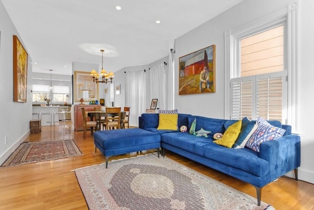 living room with hardwood / wood-style floors and a chandelier