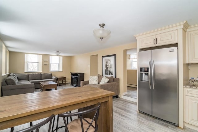 interior space with light hardwood / wood-style flooring and a baseboard heating unit