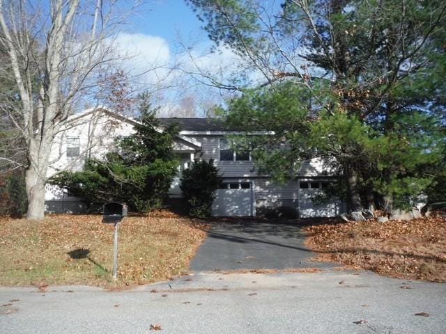 obstructed view of property with a garage