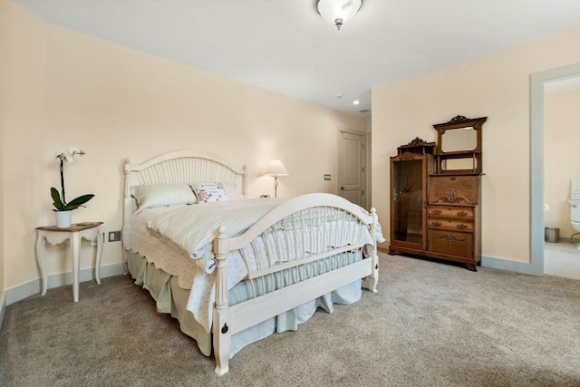 bedroom with carpet flooring and connected bathroom