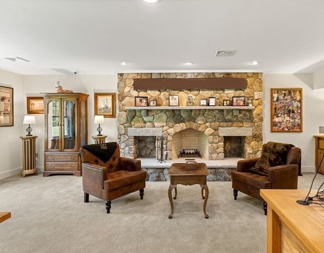 living room featuring carpet flooring and a stone fireplace