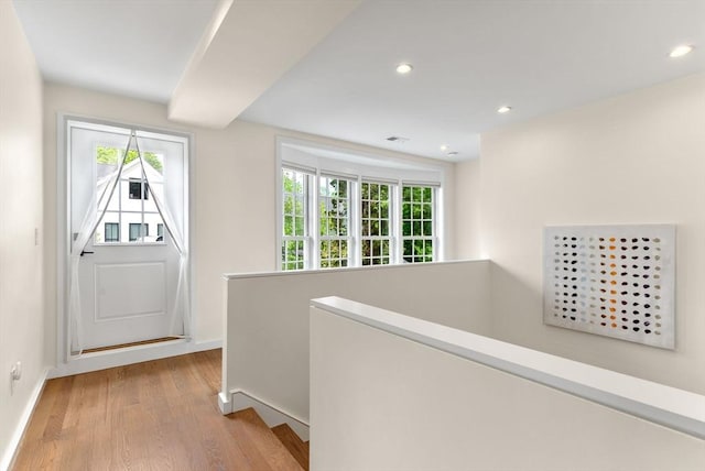 entryway featuring light wood finished floors, recessed lighting, and baseboards
