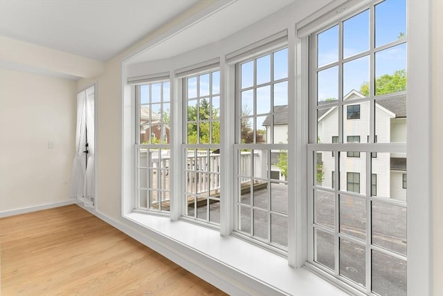 entryway featuring baseboards and wood finished floors