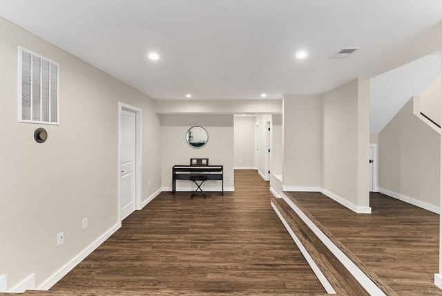 corridor with dark wood-style floors, recessed lighting, and baseboards