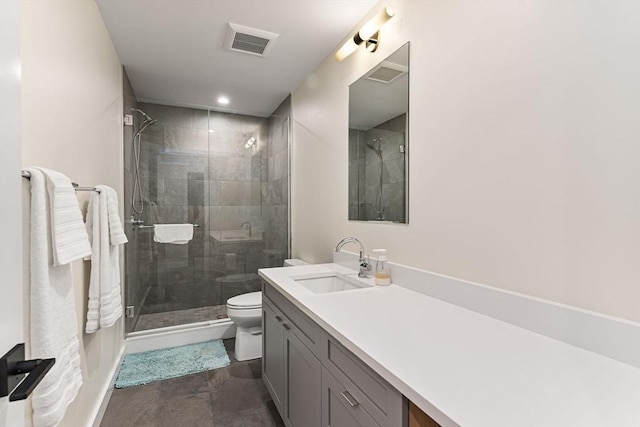 full bath featuring toilet, a stall shower, vanity, and baseboards