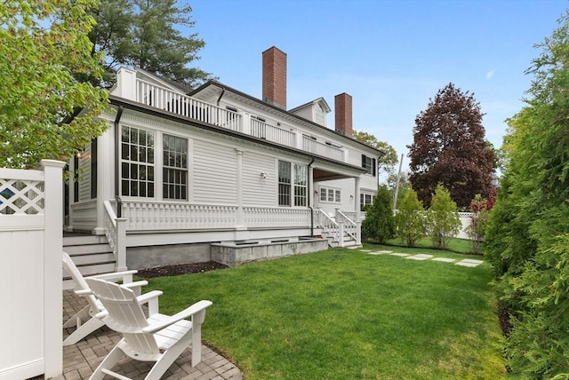 back of property featuring a chimney and stairs