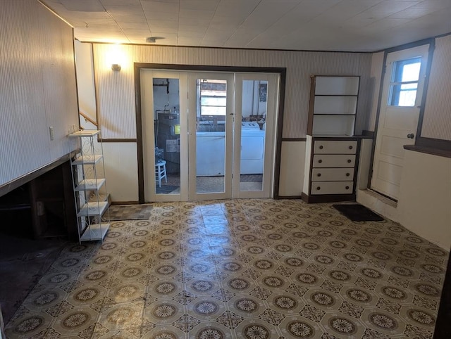 doorway to outside with washer / clothes dryer, a fireplace, water heater, and baseboards