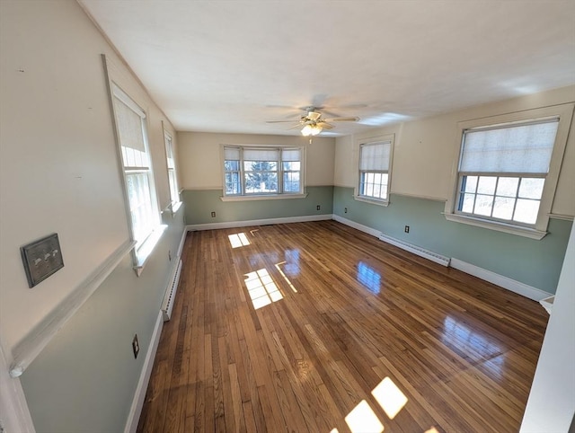 interior space featuring baseboards, wood-type flooring, and a baseboard radiator