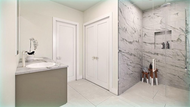 225 Middlesex Tpke Unit 101, Burlington, MA 01803 - bathroom with a sink, double vanity, a marble finish shower, and tile patterned floors