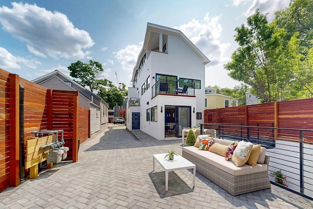 133 Charles St Unit 133, Cambridge, MA 02141 - back of property with stucco siding, a patio, a fenced backyard, and outdoor lounge area