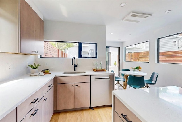 133 Charles St Unit 133, Cambridge, MA 02141 - kitchen featuring a sink, stainless steel dishwasher, light countertops, light wood-style flooring, and recessed lighting