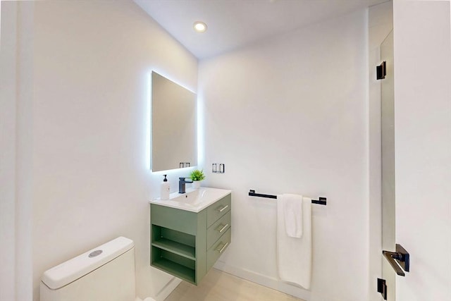 133 Charles St Unit 133, Cambridge, MA 02141 - bathroom featuring toilet, vanity, baseboards, and recessed lighting