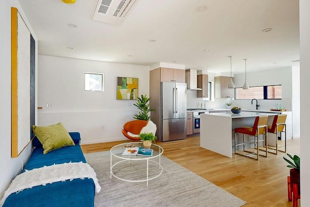 133 Charles St Unit 133, Cambridge, MA 02141 - living area featuring light wood-style floors, healthy amount of natural light, and baseboards